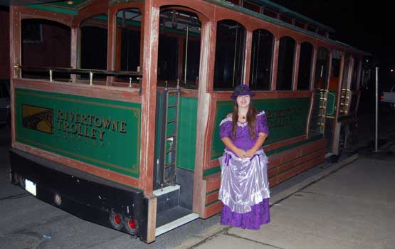 Woman standing by trolley.