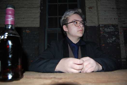 Young man sitting at table.