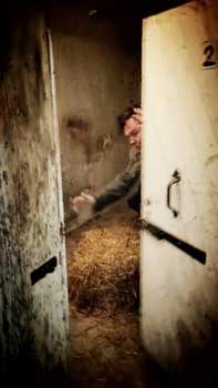 Man in dungeon cell.