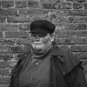 Man in front of brick wall