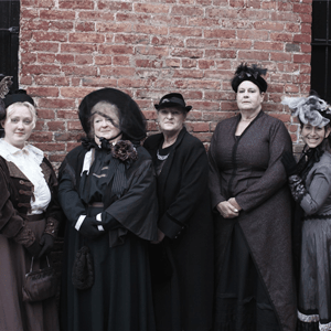Women in front of brick wall