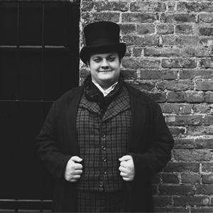 Man standing in front of brick wall