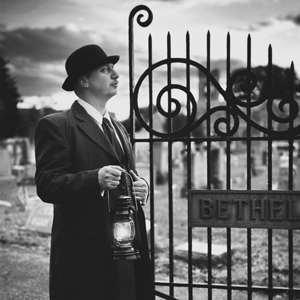 Man beside cemetery gate