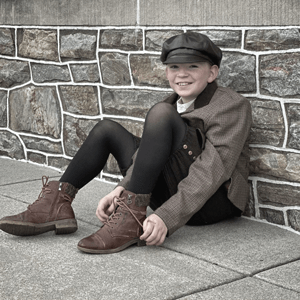 boy sitting against wall